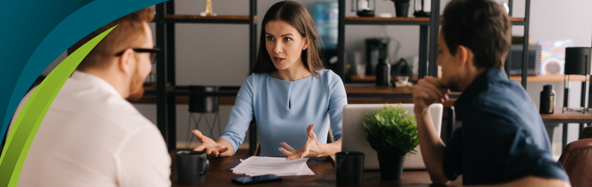 Couple speaking to woman in office